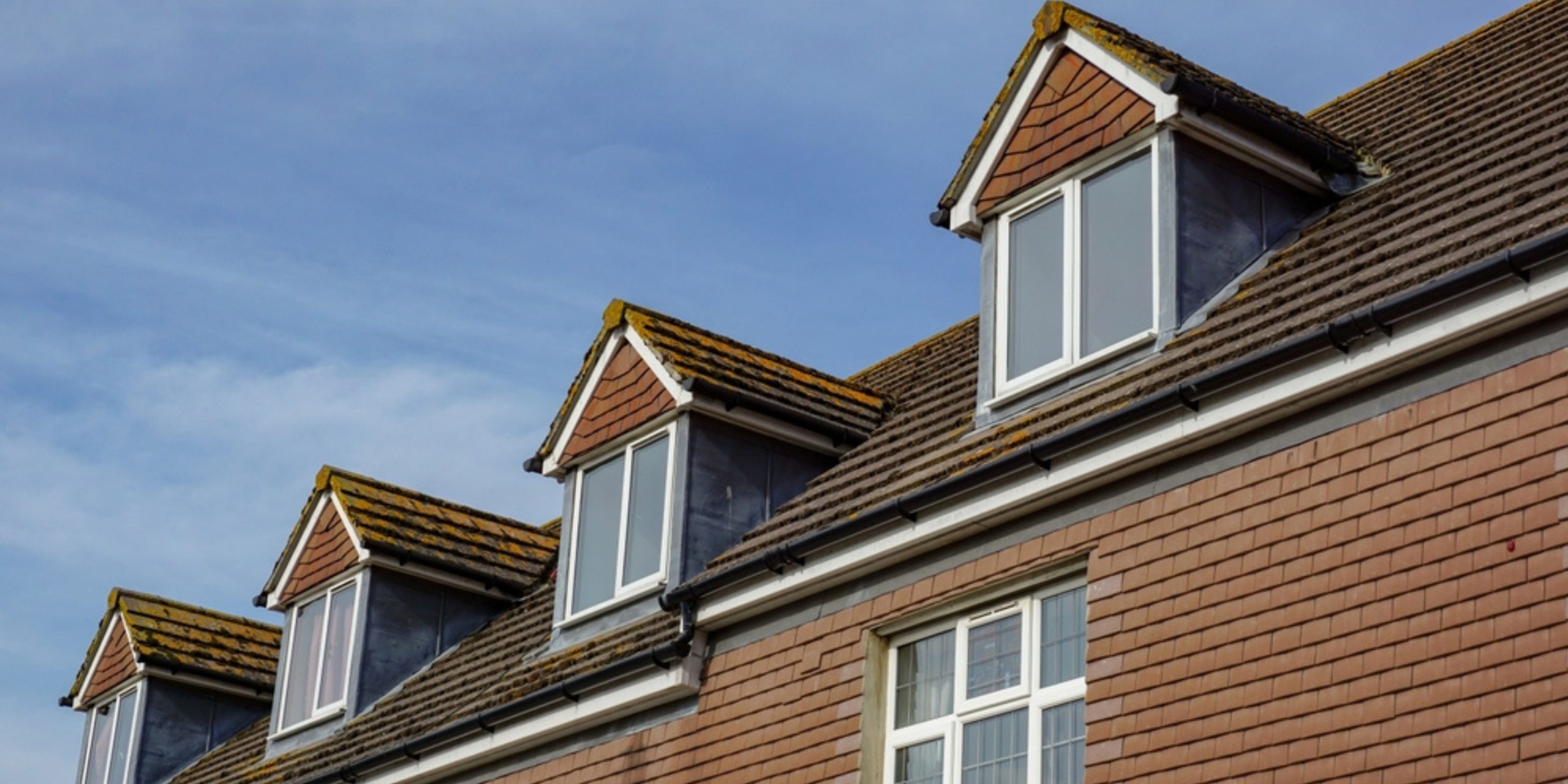 Dormer roof installation on a residential home, showcasing increased space and natural light