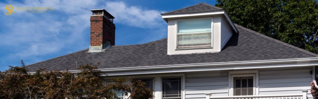 Beautiful dormer with a decorative balustrade, adding architectural elegance to a home's exterior design.